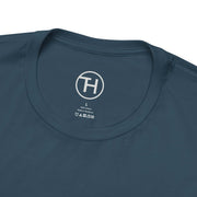 Close-up of a unisex navy blue dog lover tee with a circular logo and size label on the neckline.