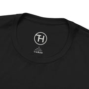 Close-up of the neckline and tag of a black unisex jersey tee made from 100% cotton.