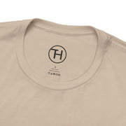 Close-up of a beige pet lovers tee collar, featuring label and logo for comfort and style.