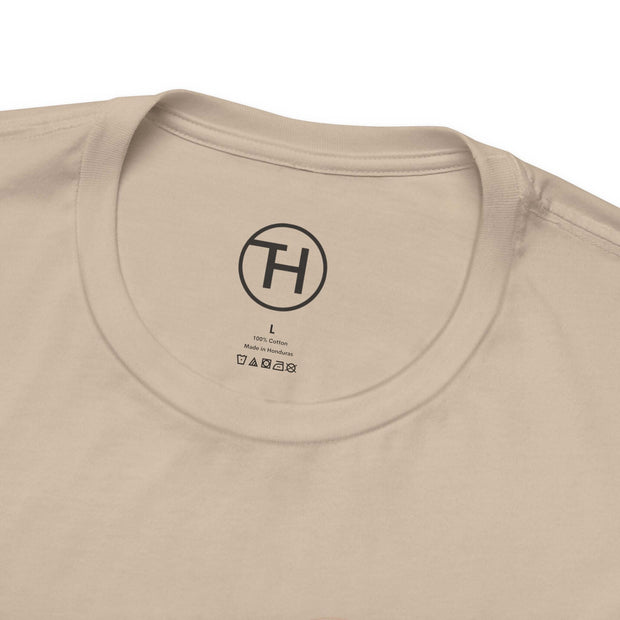 Close-up of a beige pet lovers tee collar, featuring label and logo for comfort and style.