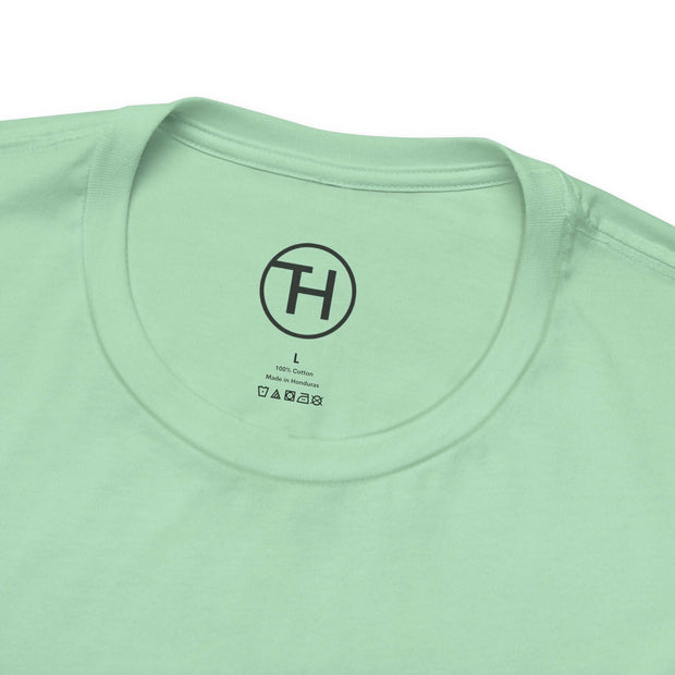 Close-up of the collar and label of a mint green Kid & Puppy Love T-Shirt made from 100% lightweight cotton.