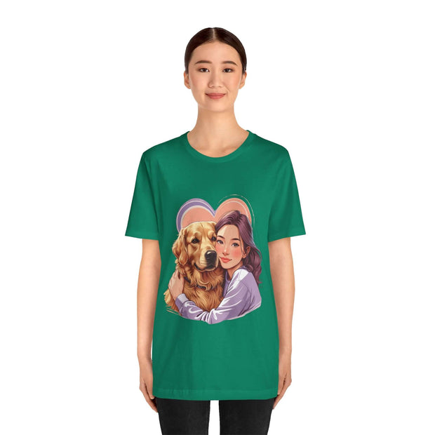 Woman wearing a green tee featuring an illustration of a girl with her golden retriever, perfect for dog lovers.