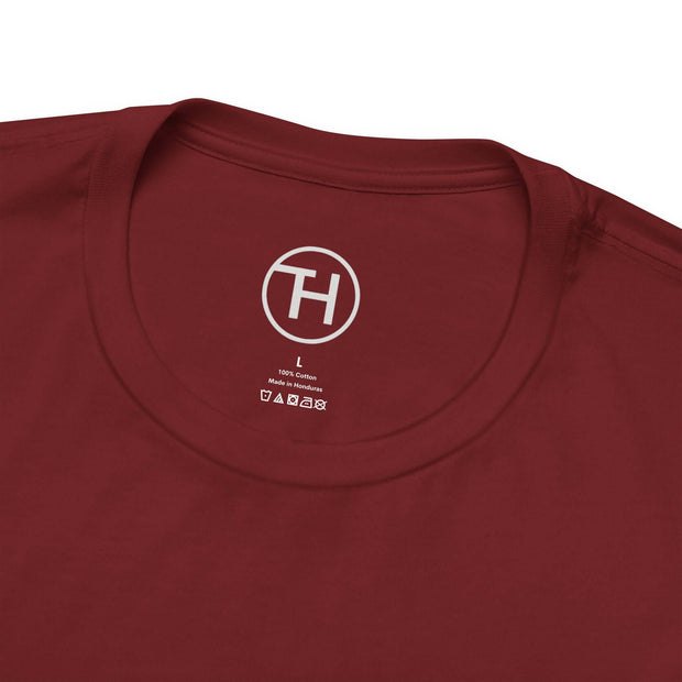 Close-up of maroon unisex jersey short sleeve tee neck label, featuring soft fabric and comfortable fit for dog lovers.